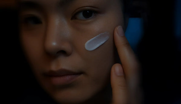 A close-up of a woman gently applying night cream to her cheek, highlighting the texture and calm ritual of skincare at night. Represents Suvéra’s Collagen Anti-Age Night Cream and the importance of rest in skin renewal.