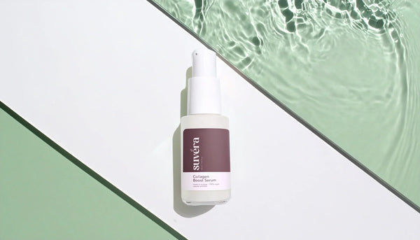Small glass pump serum bottle on mirrored floor and walls, captured diagonally from the front. Elegant minimalistic skincare packaging surrounded by reflective glass surfaces, showcasing Suvéra natural and organic skincare essence.