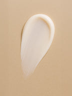 White cream smear on a beige background Light Moisturising Day Cream