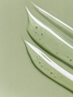 Close-up of green paint swatches on a light green background Niacinamide Gel Moisturiser