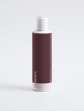 Suvera Hydrating Toner bottle next to fresh rose petals and water ripples