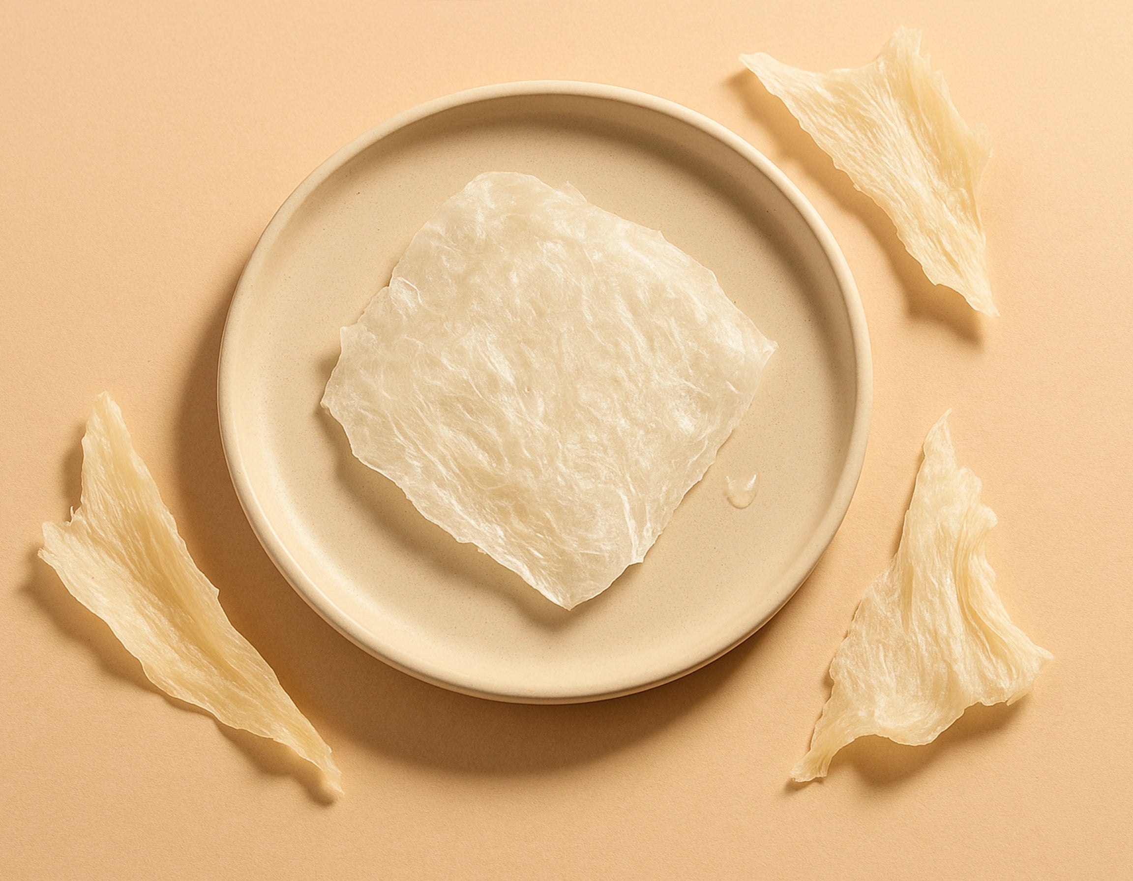 Natural collagen fibers placed on a soft ceramic plate under warm light, representing skin resilience and renewal – Suvera Self Care.