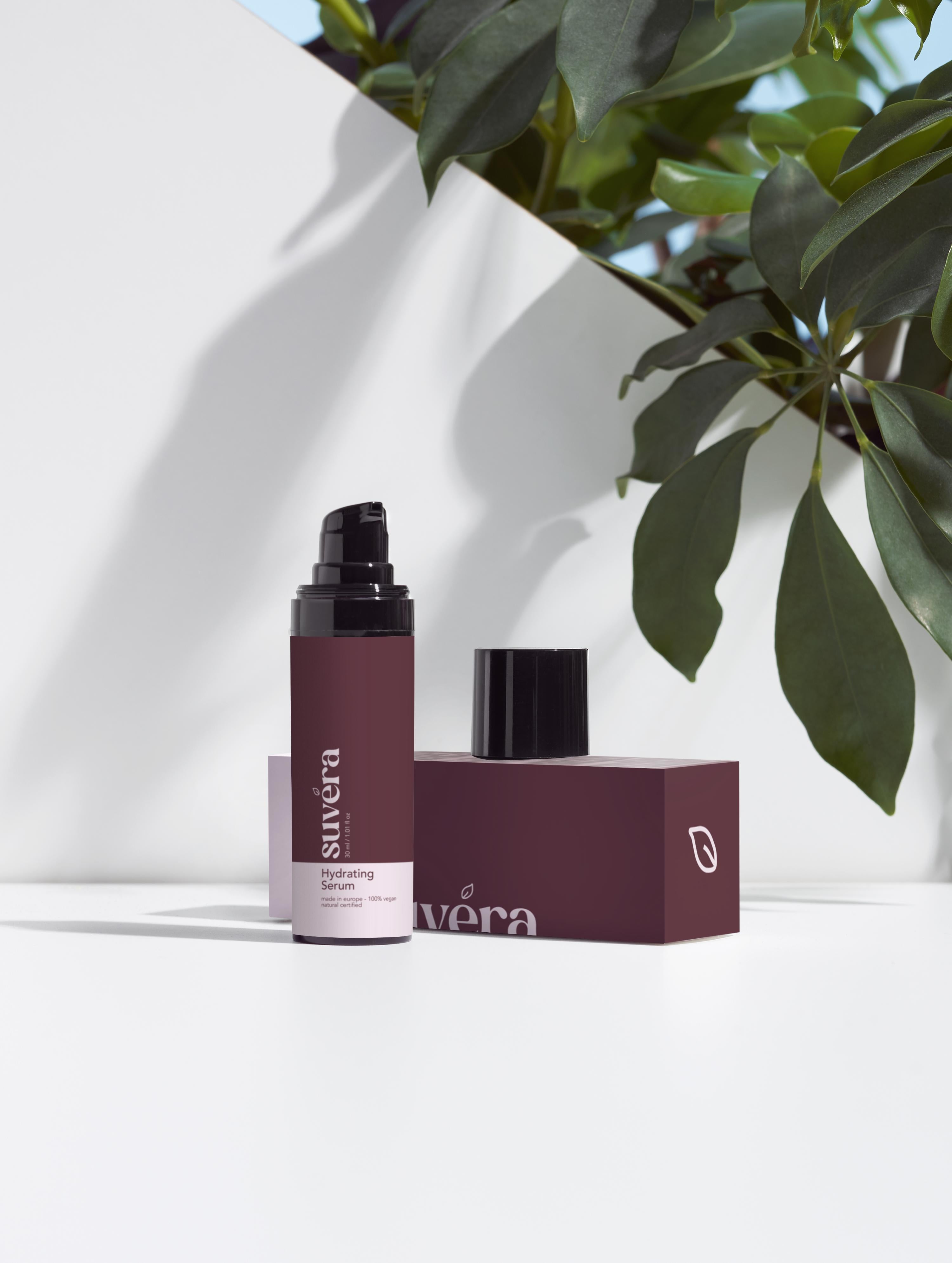 Minimalist flat lay of Suvera serum surrounded by Peony and Cloudberry accents