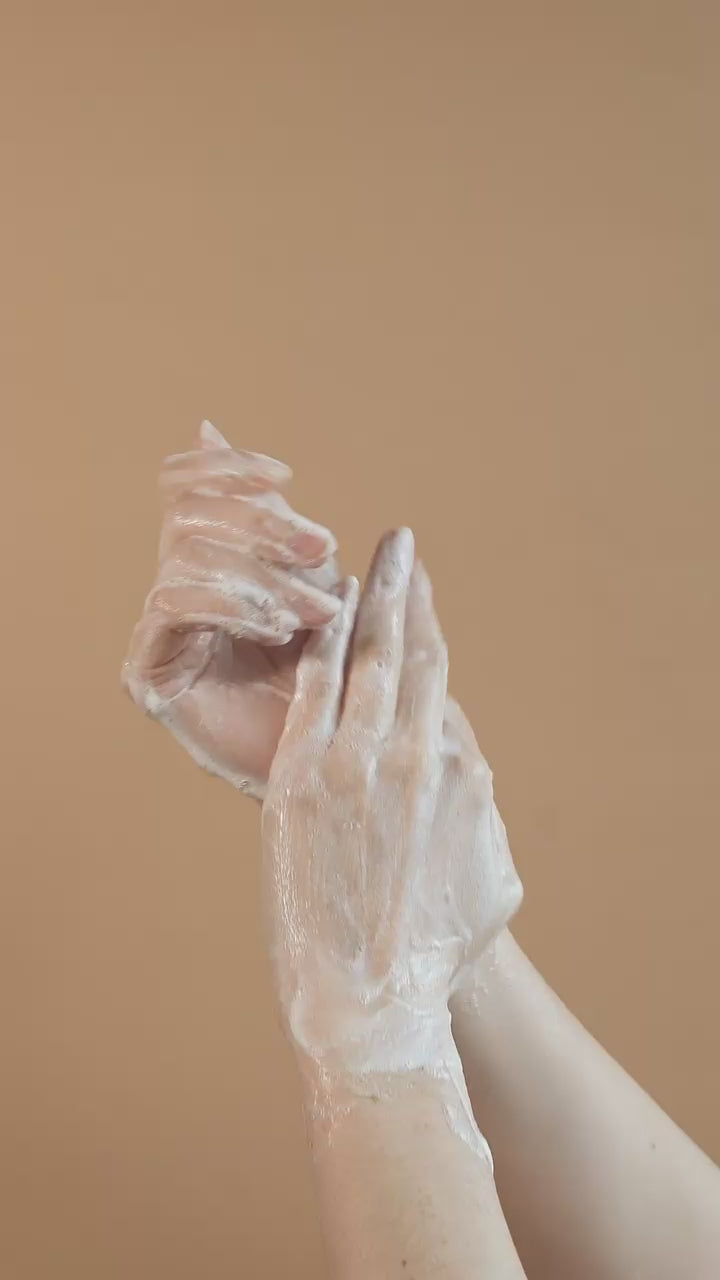 Close-up of airy soap bubbles on golden marble, premium Suvéra self care aesthetic for Patchouli & Amber Vanilla body wash.