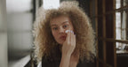 Curly model woman removing makeup naturally vegan with BiPhasic Make-up Remover, Fragrance Free